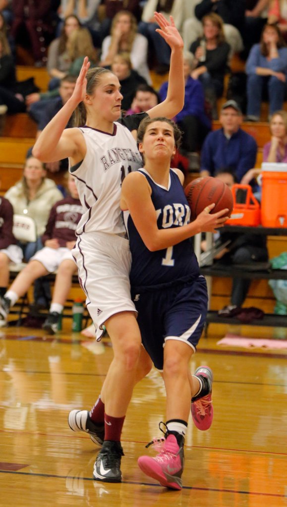 Ruby Cribby of York drives to the basket and draws a foul against Greely’s Ashley Storey. Cribby finished with 10 points.