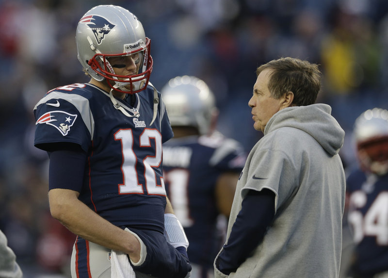 PATRIOTS PRESENT: Quarterback Tom Brady confers with Coach Bill Belichick before last week’s AFC divisional playoff game against the Houston Texans at Gillette Stadium.