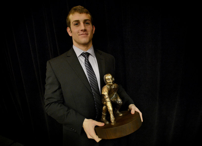 Donald Goodrich poses with the Fitzpatrick Trophy after receiving the award given to Maine’s top senior football player.