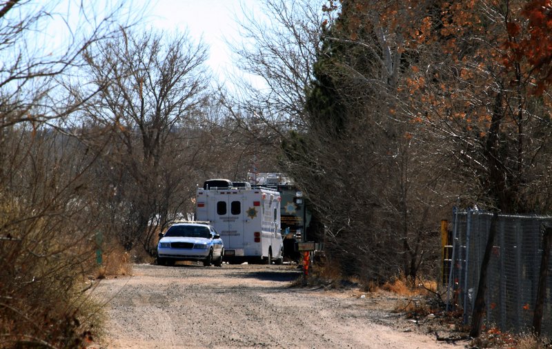 Bernalillo County authorities are stationed outside a home south of Albuquerque, N.M., on Sunday, where two adults and three children were found shot to death.