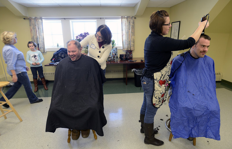 Volunteer Laurie Ferguson of Saco shares a laugh with John Pesaturo Sr. of Old Orchard Beach as she cuts his hair. To the right, Amy DesRoberts of Saco cuts hair for Noah Warner of Biddeford during the First Parish Congregational Church, UCC of Saco, Martin Luther King Jr. Day of Service event Monday, Jan. 21, 2013.
