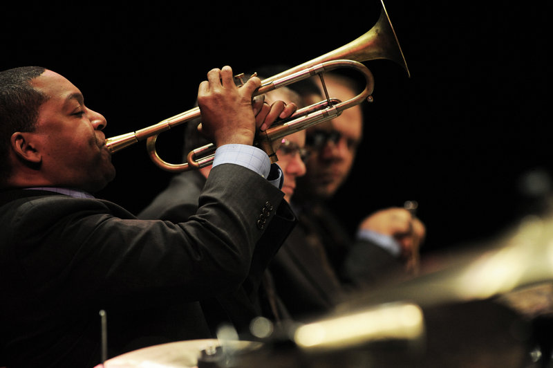 Wynton Marsalis plays as other members of the Jazz at Lincoln Center Orchestra look on. The group has been performing around the world and participating in educational programs for 25 years. They will play a concert at Merrill Auditorium at 8 p.m. Friday as part of their 25th anniversary tour.