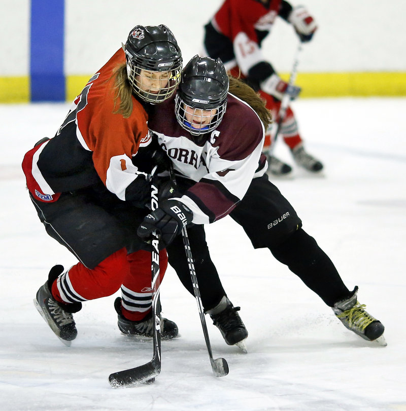 Sarah Martens, left, of Scarborough, tries to check Rachel Litif of Gorham/Bonny Eagle off the puck in the second period.