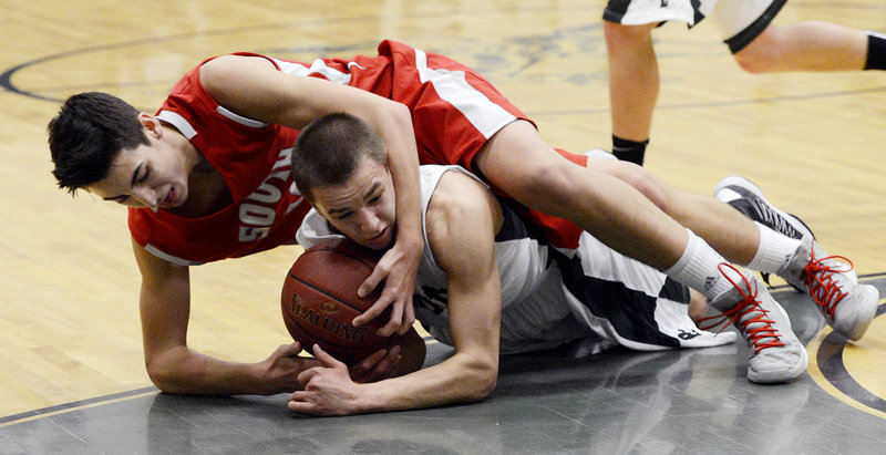 A wrestling move on the court? It looks like one as South Portland’s Calvin Carr battles for a loose ball with Dustin Cole of Bonny Eagle during Monday’s SMAA boys’ basketball game at Standish.