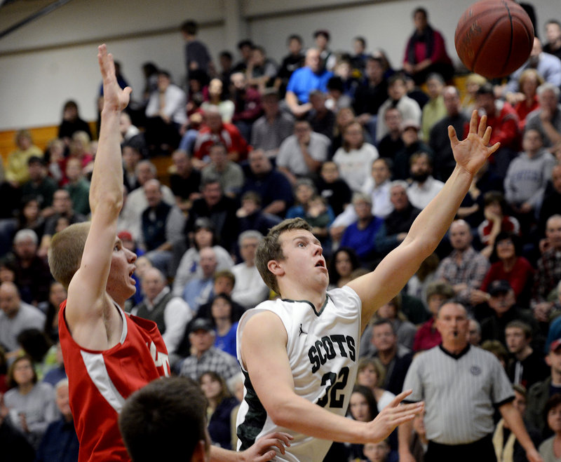 CJ Autry of Bonny Eagle drives to the basket as South Portland’s Tanner Hyland moves in on defense Monday. Autry had six points and five rebounds in the Scots’ double-overtime loss at home.