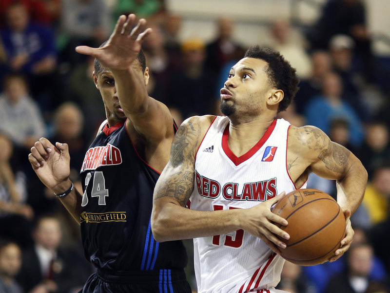 Maine’s Xavier Silas drives past Springfield’s Carleton Scott in the Red Claws’ 106-92 win Monday at Portland. Silas, one of six Red Claws in double figures, had 13 points.