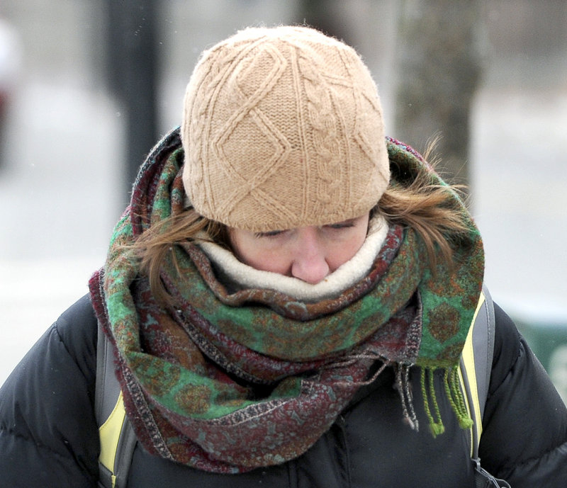Holly Hurd-Forsyth from Peaks Island keeps her head down against the cold wind as she walks to work Tuesday, Jan. 22, 2013.