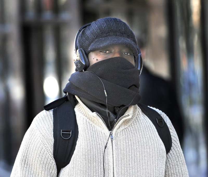 Orphee Baranshamaje from Portland is one of many pedestrians who braved the cold and wind Tuesday, Jan. 22, 2013.