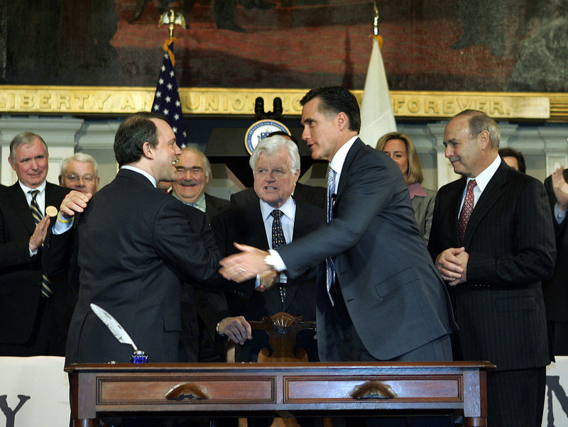 Then-Gov. Mitt Romney, right, in 2006 celebrates after signing into law a bill designed to guarantee all state residents have health insurance. Other states are looking to the Bay State for guidance as they prepare to develop their own systems.