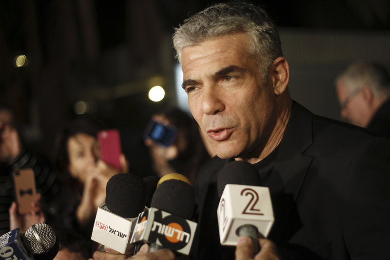 Yair Lapid, leader of a party that won 19 seats in Israel’s parliament Tuesday, speaks to reporters in Tel Aviv Wednesday.