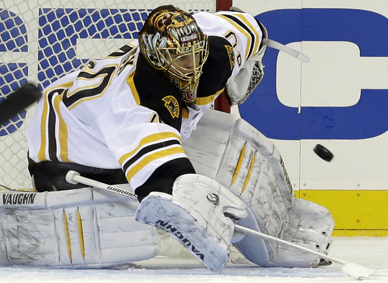 Tuukka Rask of the Bruins makes a stick stop in the first period Wednesday night in New York. The Rangers beat Rask and the Bruins 4-3 in overtime.