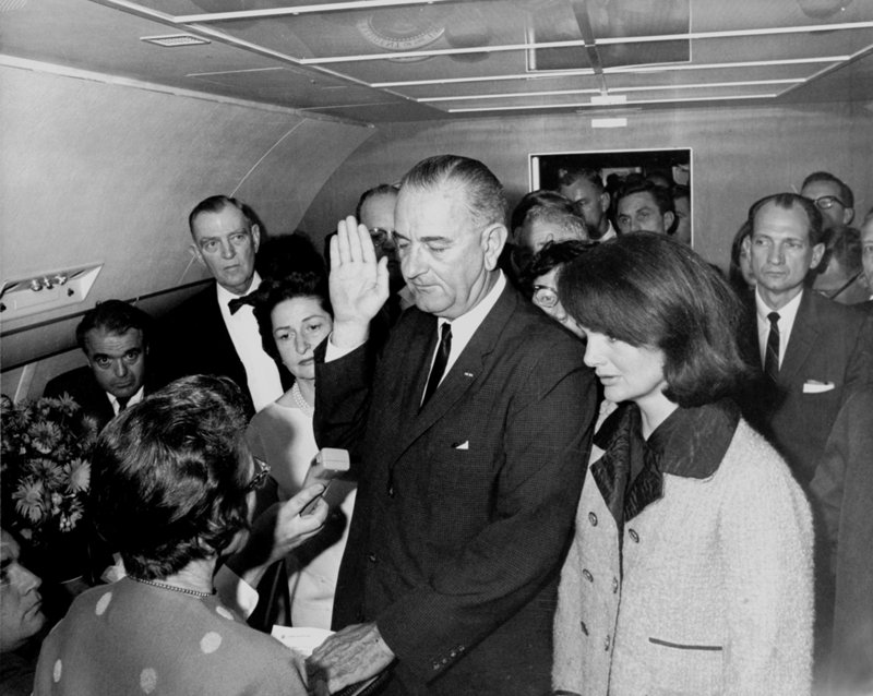 The only woman to swear in a president of the United States was Judge Sarah T. Hughes. Seen here but with her back to the camera, Hughes administered the oath of office to Lyndon Johnson on Air Force One following the assassination of John F. Kennedy. Jacqueline Kennedy looks on at right.