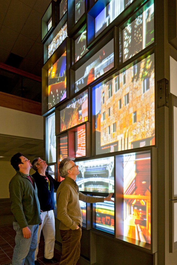 Martin Simpson, left, architect John Turk and curator Robert Wolterstorff study the tower before its move to the Portland Museum of Art.