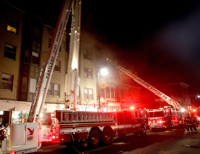 Portland firefighters tackle a blaze at 660 Congress St. on Jan. 14, 2010. Nearly all of the 25 or so Maine fire departments represented by the Professional Firefighters of Maine use a 24-hour-shift schedule.