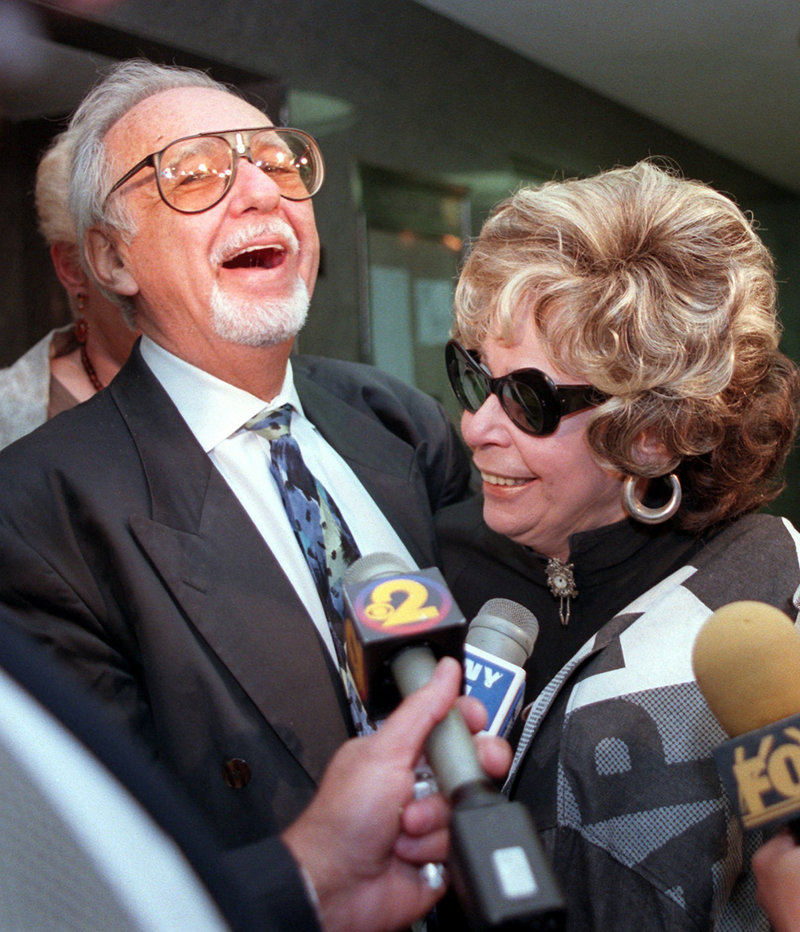 Burton Pugach laughs with his wife, Linda, outside Queens Criminal Court in New York in 1997, where he was on trial for threatening another, younger woman after she left him.