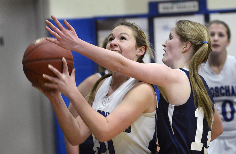 Abby Dubois, who scored 17 points Tuesday for Old Orchard Beach, heads to the basket against Jessica Smith of Greater Portland Christian during their schoolgirl basketball game. Old Orchard improved to 10-4 with a 79-45 victory at home.