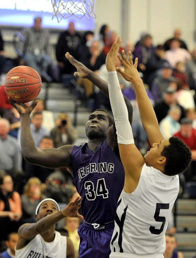 Thiwat Thiwat of Deering has his eyes on the basket while defended by Matt Talbot of Portland, which ended a two-game losing streak – its only two losses of the season. Deering dropped to 12-2.
