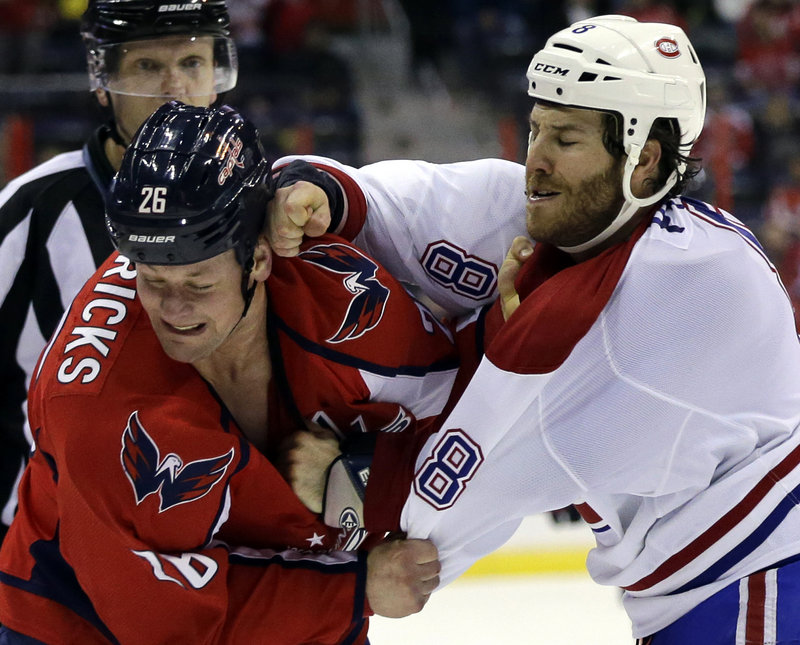 Washington Capitals center Matt Hendricks turns from a roundhouse right by Montreal Canadiens winger Brandon Prust during Thursday’s game, won by Montreal.