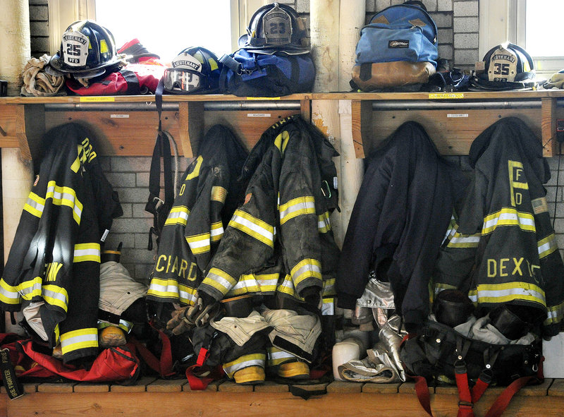 A wall at the station is lined with firefighters' gear.