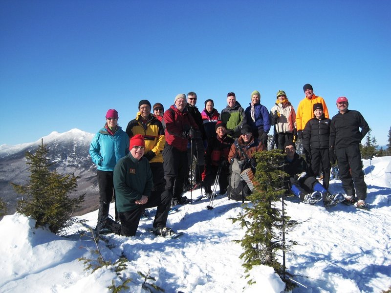 Maine AMC members, shown standing atop Little Bigelow Mountain on a picture-perfect winter’s day, find this season invigorating and are always looking for new friends to join their most active chapter of the Appalachian Mountain Club.