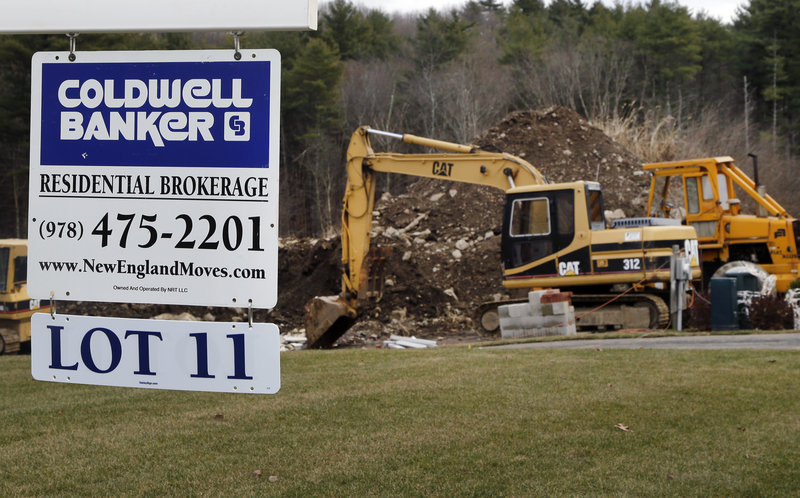 A sign hangs in North Andover, Mass., where a house was under construction during December.