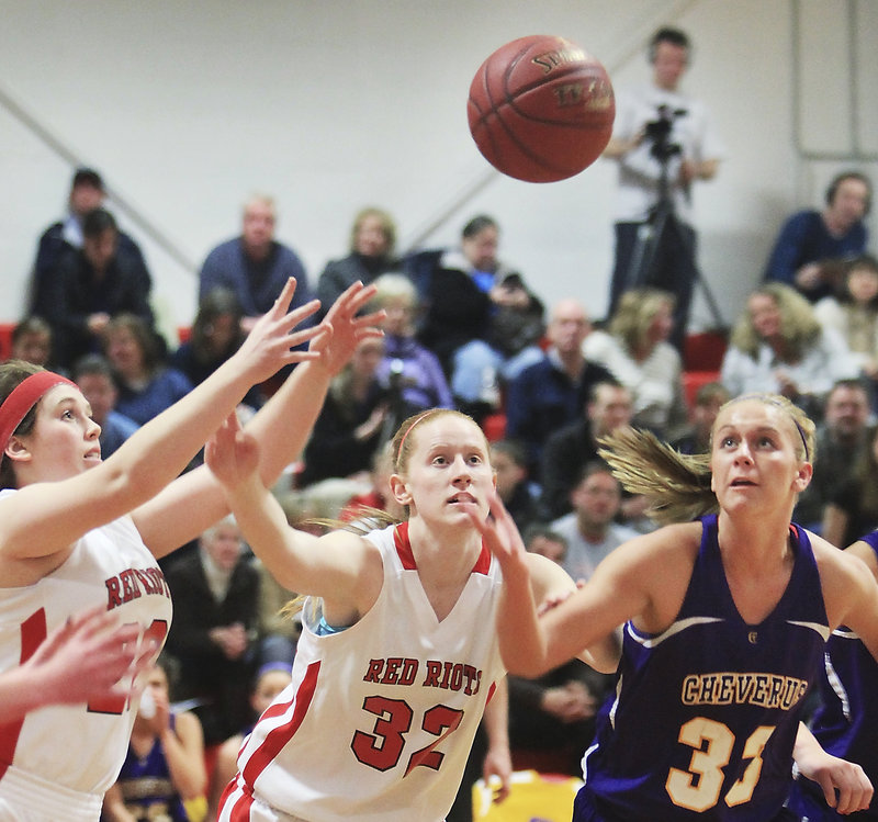 Emily Gray, left, and Hope Owen of South Portland reach for a loose ball along with Kylie Libby of Cheverus. Cheverus won, 43-33.