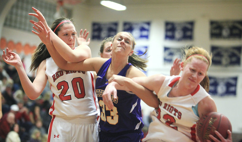 Hope Owen, right, of South Portland tries to protect the ball from Kylie Libby of Cheverus as Meaghan Doyle joins the skirmish Friday night. Cheverus improved to 11-2 with a 43-33 victory.