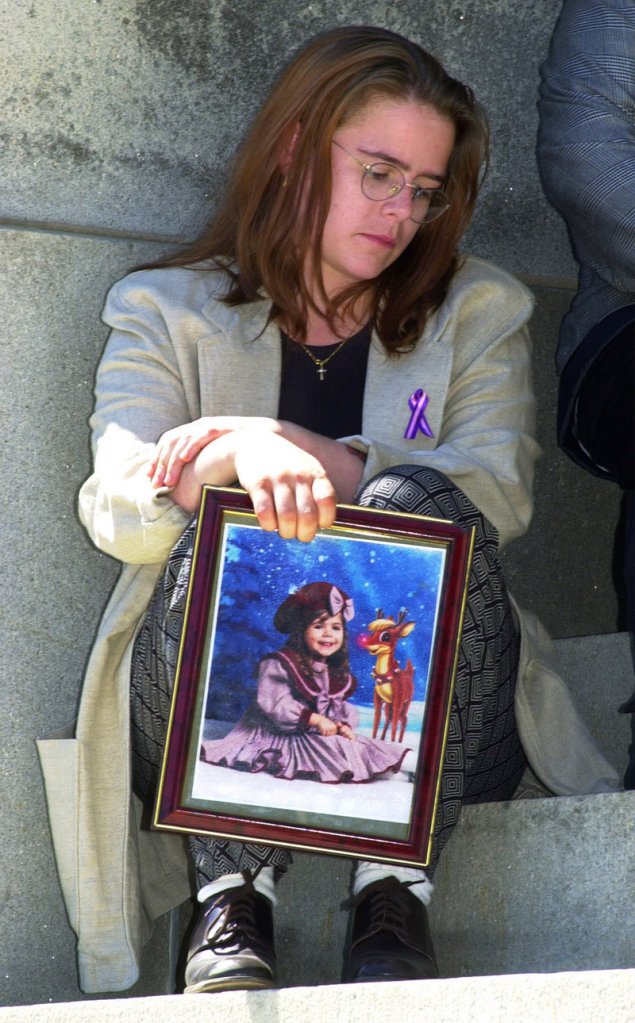 Christy Marr sits outside the State House in Augusta after an April 2003 news conference. The 2001 death of Marr’s 5-year-old daughter Logan, who was in foster care at the time, led to major changes in Maine’s system. One of those changes was an emphasis on placing children with family members.
