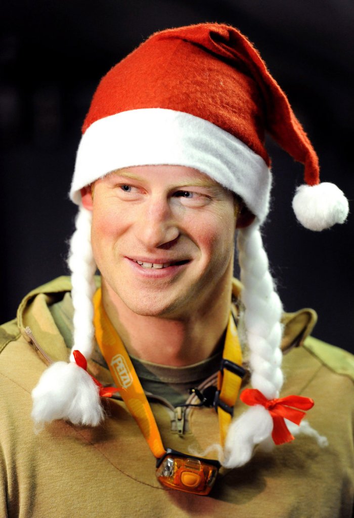 In a Dec. 12, 2012, file photo, Britain's Prince Harry wears a Santa hat as he shows a media crew his sleeping area at the VHR (very high readiness) tent, close to the flight-line, at Camp Bastion in southern Afghanistan. During Prince Harry's 20-week deployment in Afghanistan, he served as an Apache helicopter pilot with the Army Air Corps.