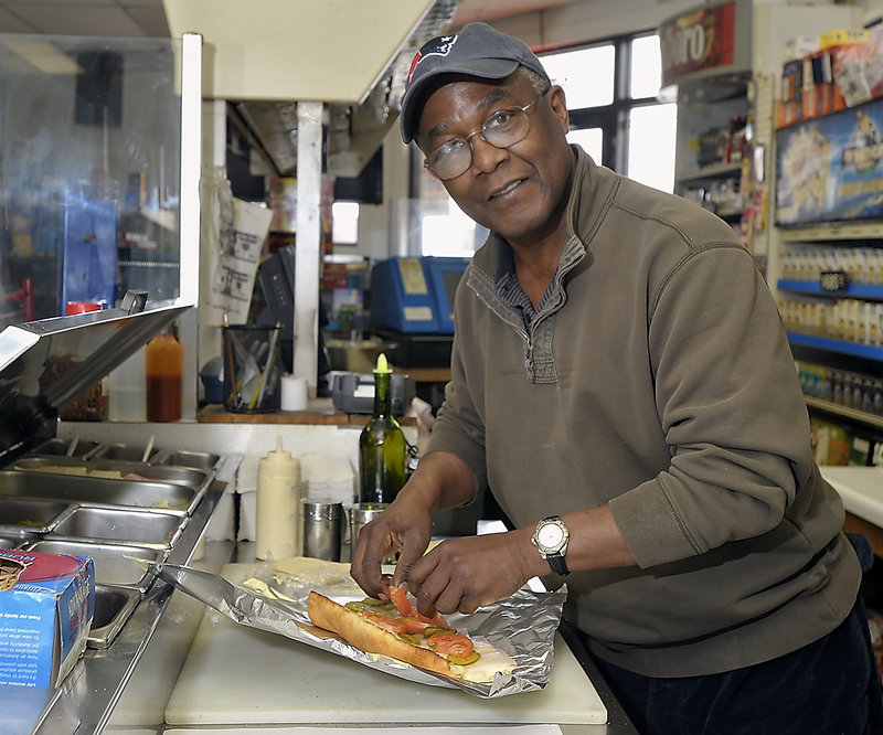 Vespucci’s owner David Wagabaza makes a ham and Swiss Italian sandwich for a lunchtime customer.