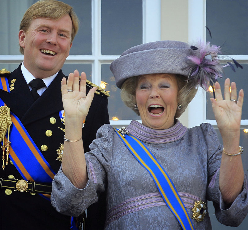 Dutch Queen Beatrix and Dutch Crown Prince Willem-Alexander, left, wave to wellwishers from the balcony of Royal Palace Noordeinde.