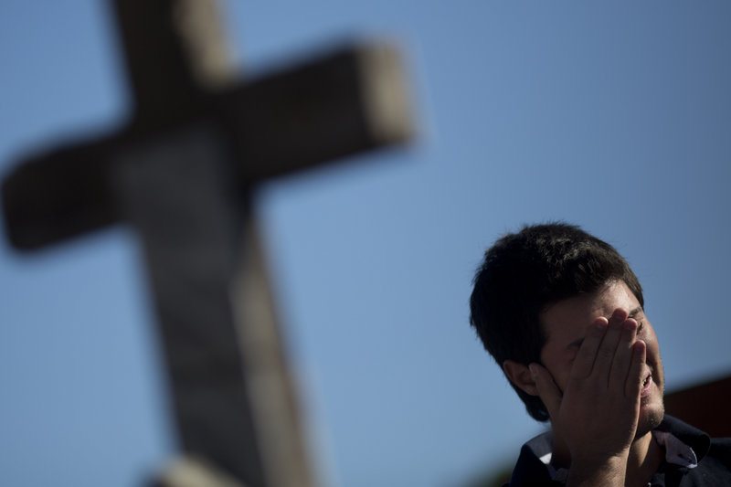 A man cries Monday at the burial of a victim who died in the nightclub fire in Santa Maria, Brazil.