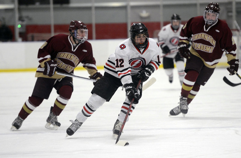 Scarborough’s Garrett McDonald controls the puck as he heads down the ice during the Red Storm’s 4-3 win over Thornton Academy on Monday.
