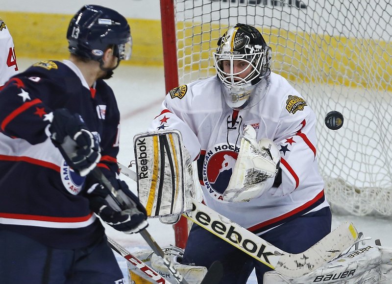 East goalie Niklas Svedberg of the Providence Bruins makes a save on Gustav Nyquist – a former UMaine player – of the Grand Rapids Griffins Monday night in the AHL All-Star game at Providence, R.I. The West won, 7-6.