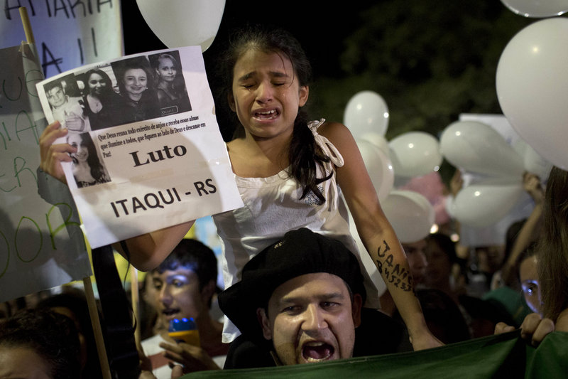 A girl cries during a march in a plaza near the Kiss nightclub honoring the victims of Sunday’s fatal fire inside the club in Santa Maria, Brazil, on Monday.