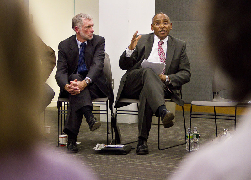 Eskinder Negash, right, the director of the federal Office of Refugee Resettlement addresses a meeting at the Portland Public Library. He was accompanied by Larry Bartlett, another federal refugee official.