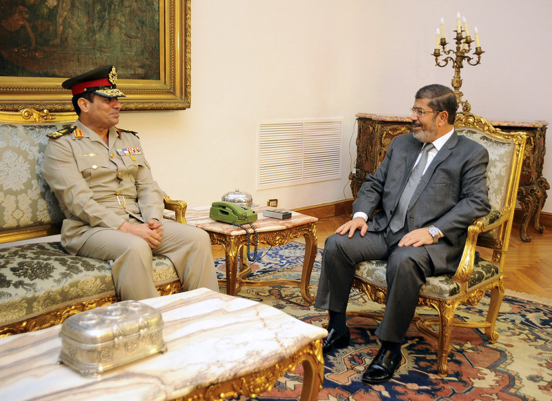 Gen. Abdel-Fattah el-Sissi, Egypt’s defense minister, left, meets with President Mohammed Morsi in Cairo on Monday. On Tuesday, the army chief warned the state could collapse.