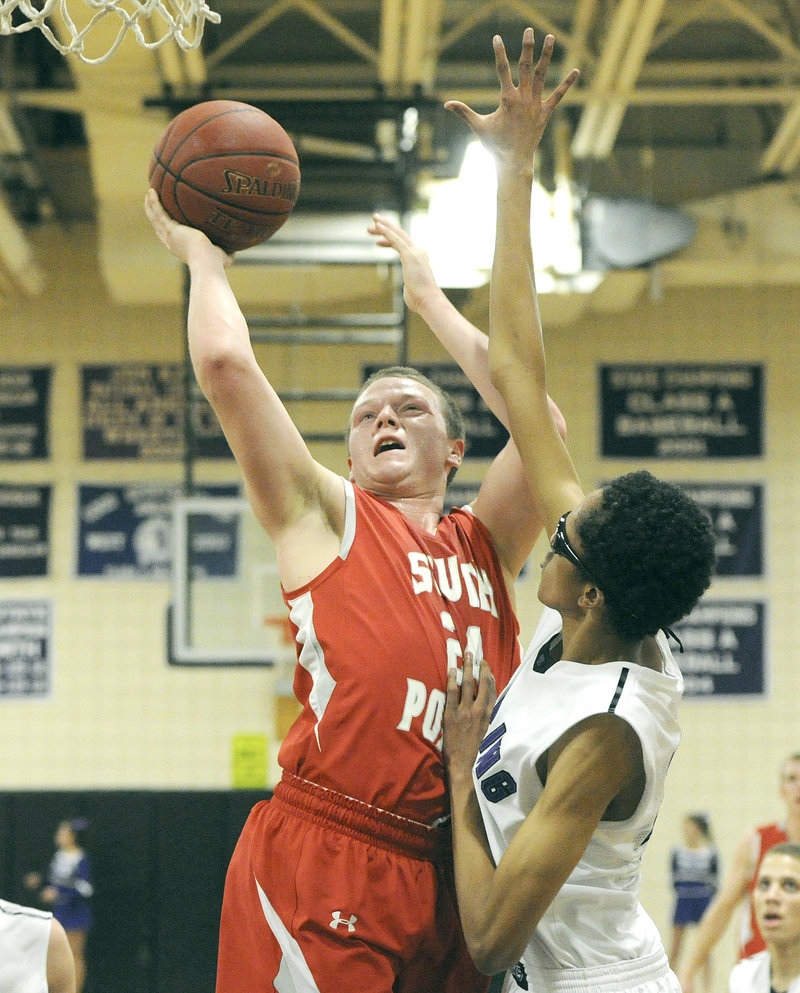 Conner MacVane of South Portland powers his way to the basket Tuesday night while guarded by Ahmed Ali of Deering.