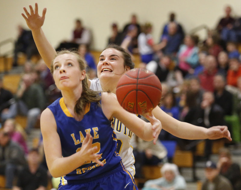 Miranda Chadbourne of Lake Region looks for a shot after beating Falmouth’s Molly Ryan off the dribble in Tuesday night’s Western Maine Conference girls’ basketball game at Falmouth. Lake Region won, 54-31.