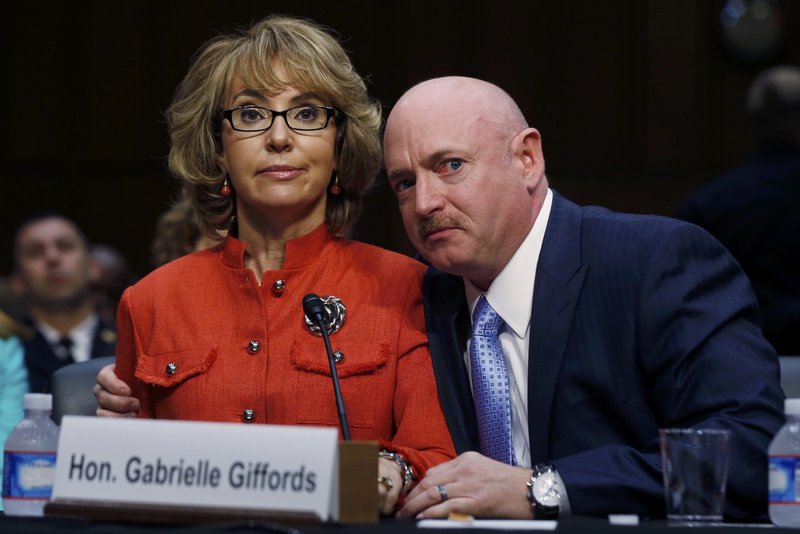 Former U.S. Rep. Gabrielle Giffords, flanked by her husband, Mark Kelly, delivers her opening remarks Wednesday at a Senate Judiciary panel hearing about guns and violence.
