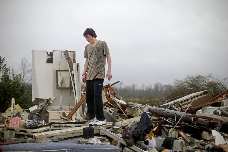 Will Carter, 15, discovers extensive damage to his house after arriving home from school following a tornado that touched down Wednesday in Adairsville, Ga.