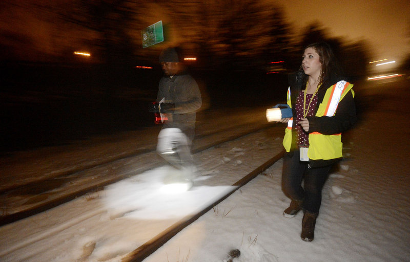 Harrison Deah, a supervisor with the Oxford Street Shelter, and Sara Fleurant, of the shelter’s housing council, search for homeless people along the railroad tracks behind Deering Oaks park in Portland on Wednesday. Shawn Patrick Ouellette/Staff Photographer