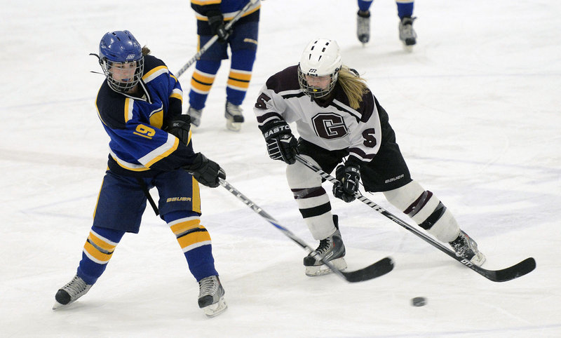 Martina St. Angelo of Falmouth passes the puck Wednesday night as Meg Finlay of Greely skates in to apply pressure. Greely increased its undefeated run to 11 games and improved to 14-2-1 by coming back for a 5-1 victory.