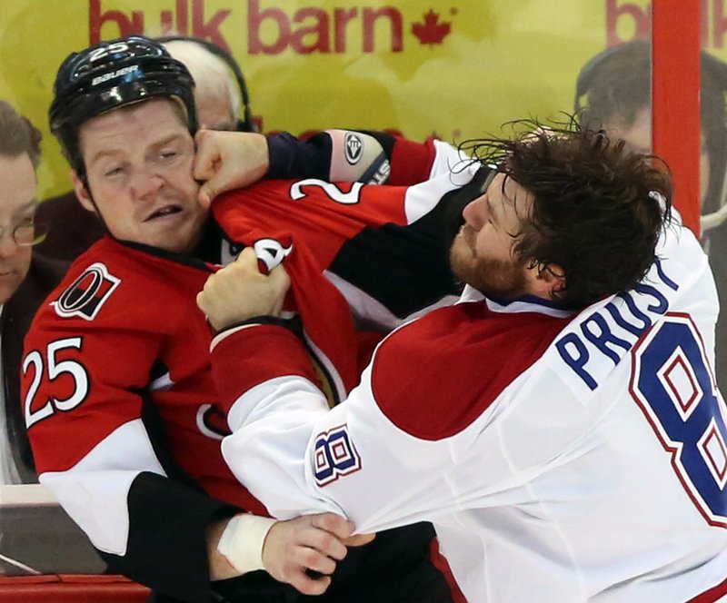 Brandon Proust of Montreal lands a punch to Chris Neil’s face in Wednesday night’s game at Ottawa. The Senators ended Montreal’s four-game winning streak, 5-1.