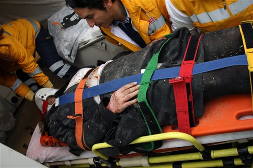 Medics and firefighters carry an injured woman on a stretcher to an ambulances after a suicide bomber had detonated an explosive device at the entrance of the U.S. Embassy in the Turkish capital, Ankara, Turkey, Friday, Feb. 1, 2013. A suspected suicide bomber detonated an explosive device at the entrance of the U.S. Embassy in the Turkish capital on Friday, killing himself and one other person, officials said. (AP Photo/Burhan Ozbilici)