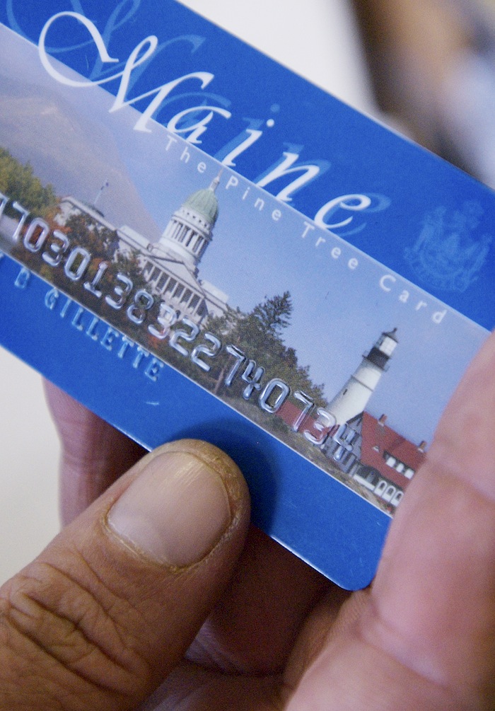 In this August 2008 file photo, Keven Gillette of Portland uses a magnetic food-stamp card to buy his groceries. Federal officials have denied a request by the LePage administration to require Mainers who use food-stamps benefits cards to show photo ID when they buy groceries.