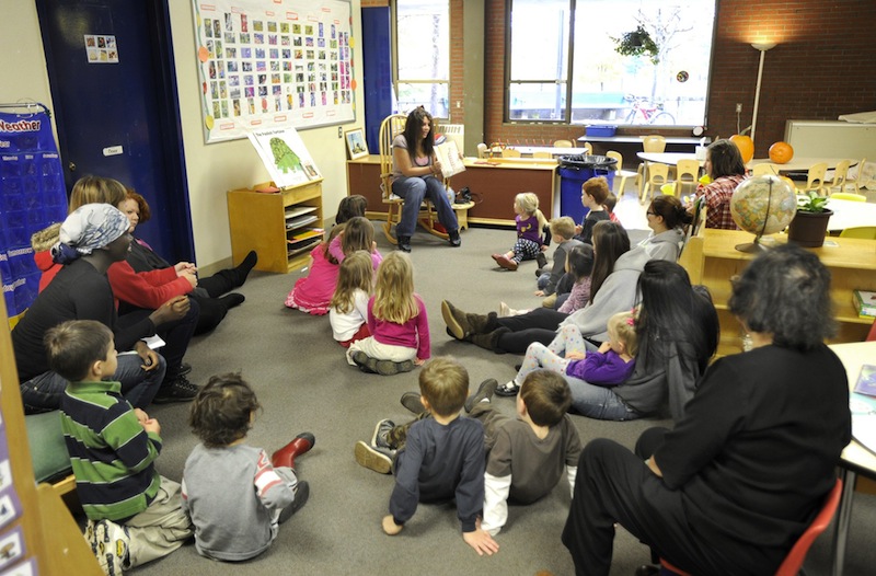 In this October 2010 file photo, Aaliyah Mills reads to preschoolers at Portland Arts and Technology School in Portland. President Obama's proposal to provide quality early-childhood education to all children, including preschool for all 4-year-olds, would mean a significant expansion of those programs in Maine, where only about 60 percent of public school districts now offer pre-kindergarten classes.