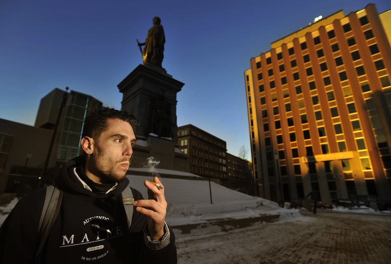 In this Jan. 7, 2012 file photo, Jason Lemay, 26, of Portland, smokes a cigarette in Monument Square. The Portland City Council on Monday, Feb. 5, 2013 voted to ban smoking in 36 city parks and open spaces, including Monument Square.