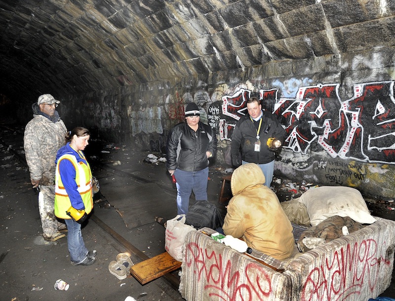 Maine HUD field director Bill Burney, Angela Havlin, Alicia Martinez and Josh O'Brien all with the Oxford Street Shelter interview a homeless man (in the tunnel) under the Casco Bay Bridge as the city of Portland conducted its annual homeless point in time survey on Wednesday, Jan. 30, 2013. City officials said Tuesday, Feb. 26, 2013 they are moving forward with proposals to reduce homelessness, including a call for proposals to build transitional housing in Portland.
