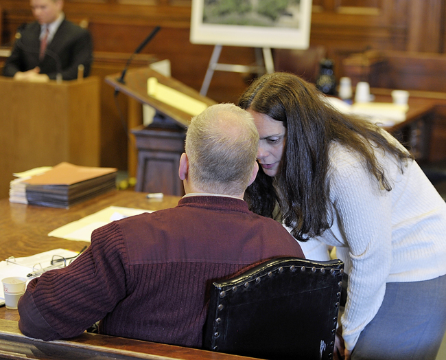 Paula Spencer briefly chats with husband Barry Spencer during a break in the trial on Wednesday.